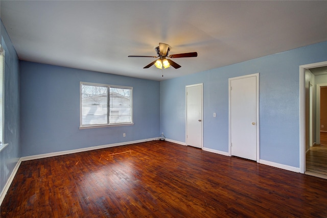 unfurnished bedroom with dark wood-style floors, ceiling fan, and baseboards