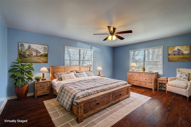 bedroom featuring ceiling fan, dark wood-type flooring, multiple windows, and baseboards