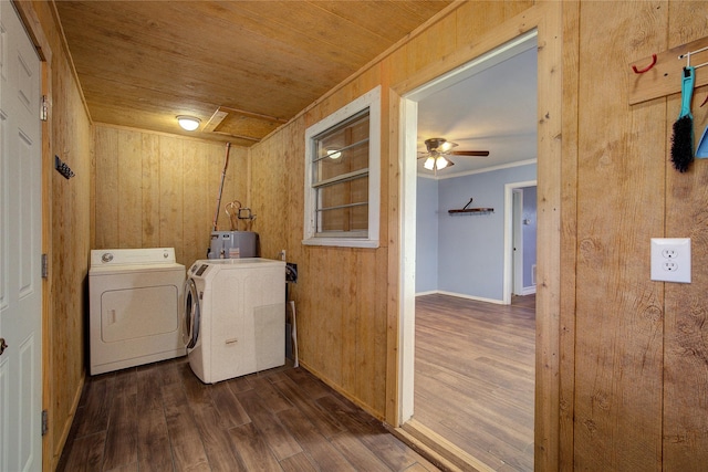 clothes washing area featuring laundry area, dark wood-style flooring, wood ceiling, washer and dryer, and water heater