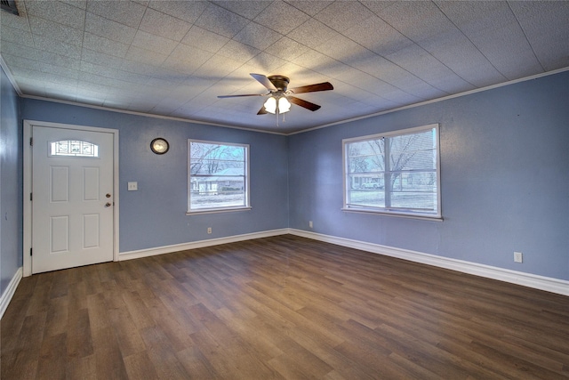 entryway featuring ornamental molding, dark wood-type flooring, ceiling fan, and baseboards