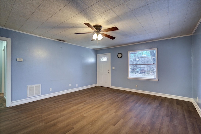 interior space with baseboards, dark wood finished floors, visible vents, and crown molding