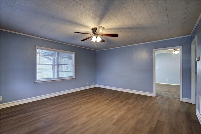 empty room with crown molding, baseboards, ceiling fan, and wood finished floors