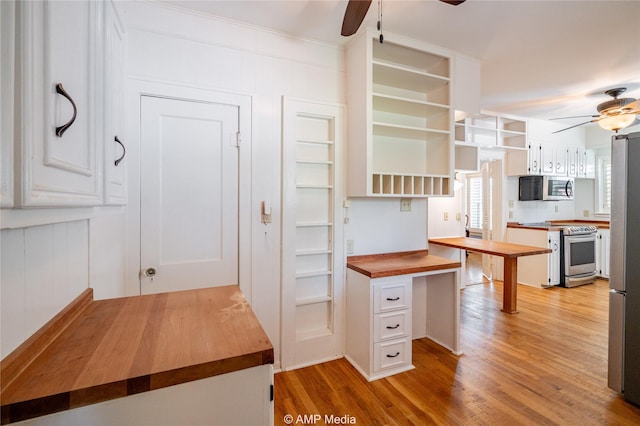 kitchen featuring stainless steel appliances, a ceiling fan, white cabinets, wooden counters, and open shelves