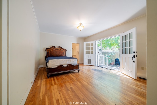 bedroom featuring light wood-type flooring, access to outside, crown molding, and baseboards