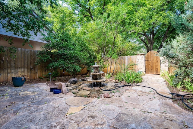 view of patio featuring fence private yard and a gate