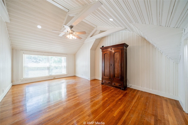 bonus room featuring lofted ceiling with beams and wood finished floors