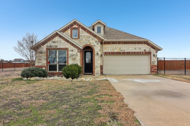 view of front of property featuring brick siding, a shingled roof, concrete driveway, an attached garage, and fence