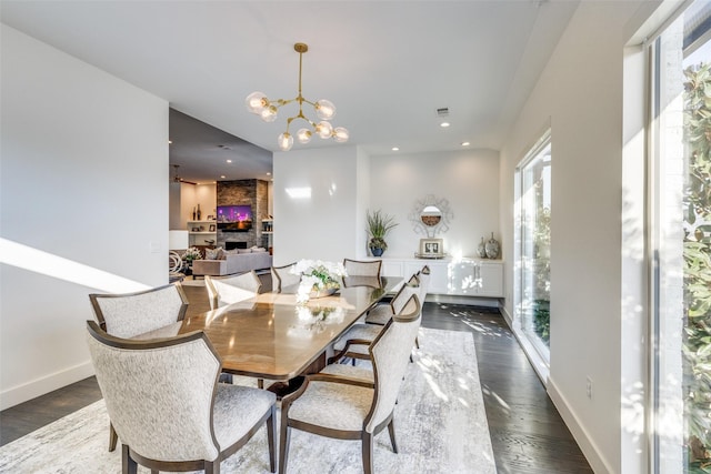 dining room featuring dark wood-style floors, baseboards, a chandelier, and recessed lighting