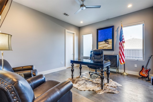 office featuring dark wood-style flooring, visible vents, ceiling fan, and baseboards