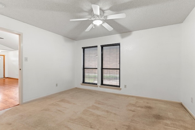 empty room with carpet flooring, a textured ceiling, and a ceiling fan