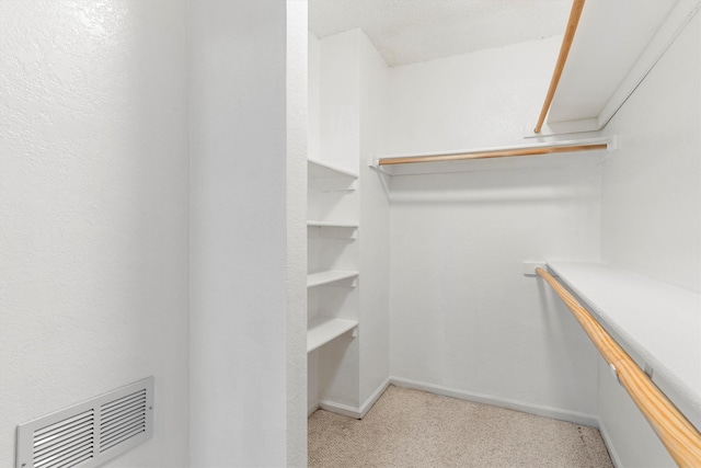 spacious closet with visible vents and carpet floors