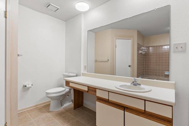 full bathroom with tile patterned floors, visible vents, toilet, tiled shower, and vanity