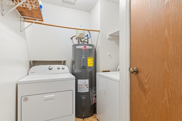 laundry room featuring a textured ceiling, laundry area, washing machine and dryer, and electric water heater