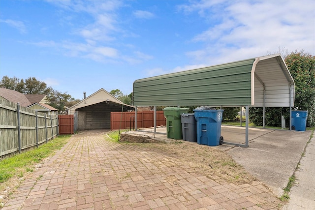 exterior space featuring a carport and fence