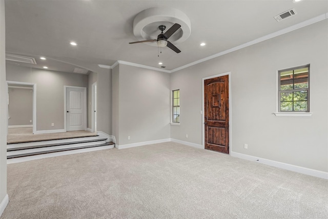 unfurnished room featuring visible vents, baseboards, attic access, and light colored carpet