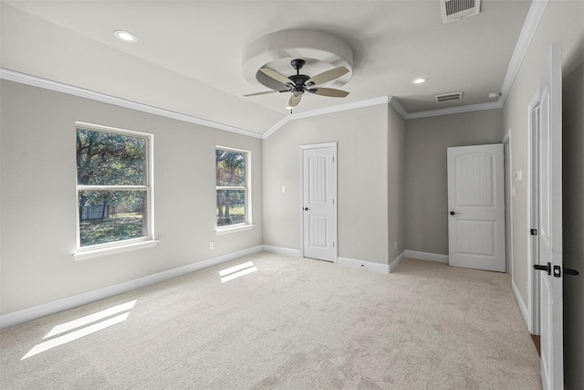 unfurnished bedroom with ornamental molding, light colored carpet, visible vents, and baseboards