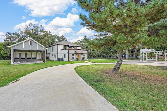 view of home's community with a lawn and concrete driveway