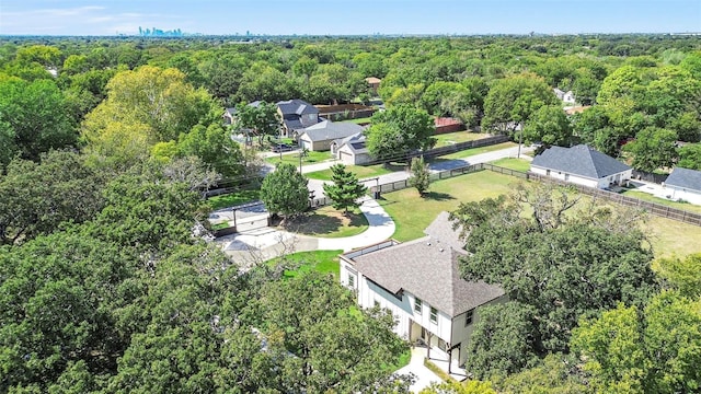 birds eye view of property featuring a wooded view