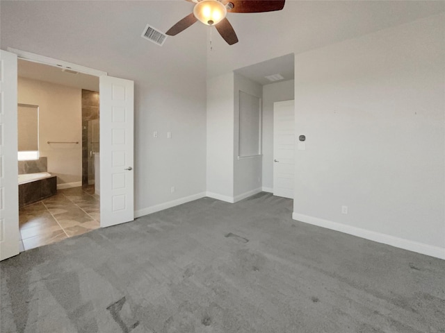 unfurnished bedroom with carpet floors, visible vents, ceiling fan, ensuite bath, and baseboards