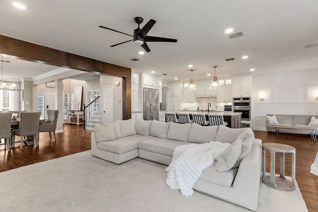 living room featuring recessed lighting, visible vents, and wood finished floors