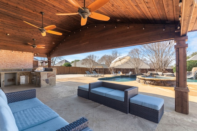 view of patio / terrace with a pool with connected hot tub, a fenced backyard, a grill, and area for grilling