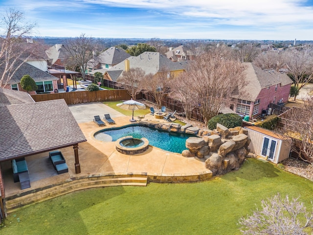 view of pool with a yard, a fenced backyard, and a residential view