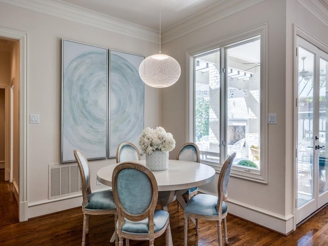 dining area with dark wood-style floors, french doors, ornamental molding, and baseboards