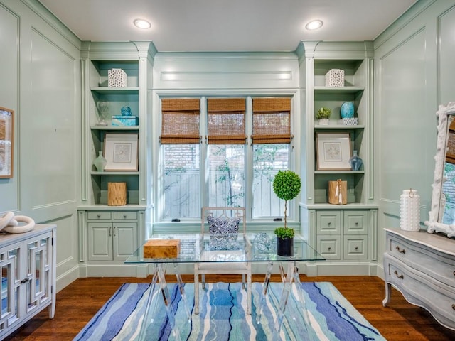 office area featuring dark wood-style floors, recessed lighting, a decorative wall, and built in shelves