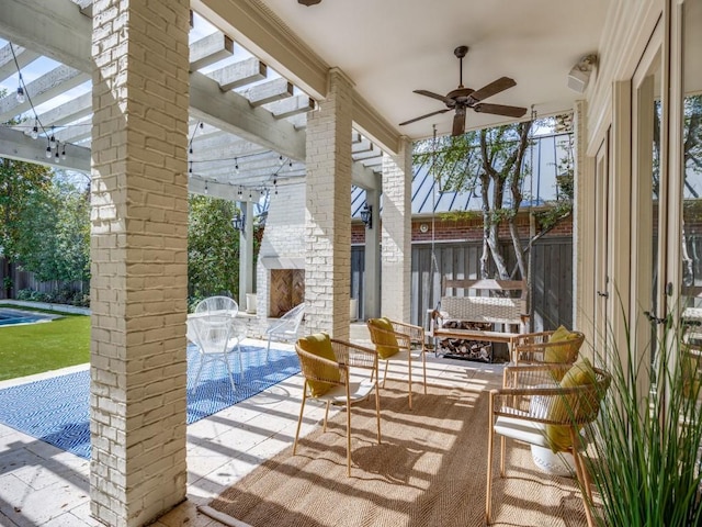 exterior space featuring ceiling fan and an outdoor brick fireplace