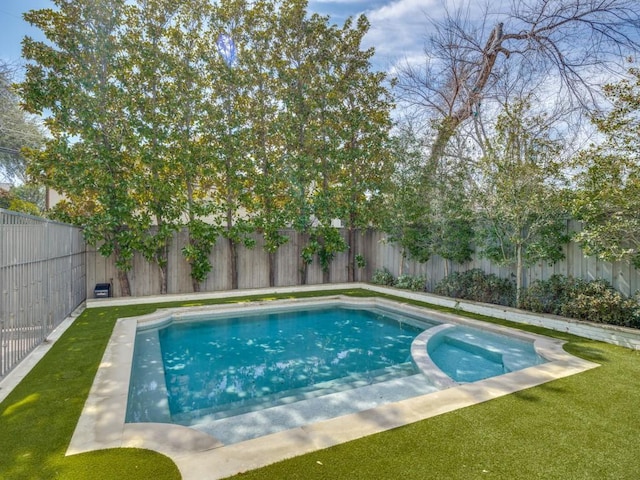 view of pool with a pool with connected hot tub, a fenced backyard, and a yard