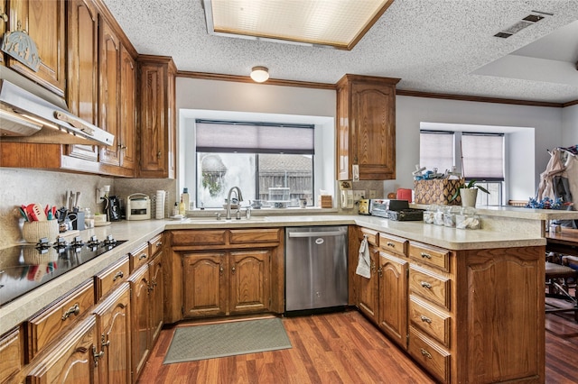 kitchen with visible vents, dishwasher, a peninsula, light countertops, and a sink