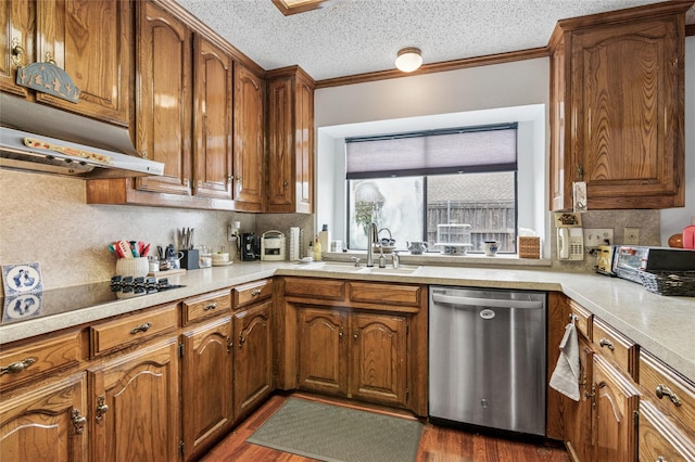 kitchen featuring ornamental molding, light countertops, dishwasher, and a sink