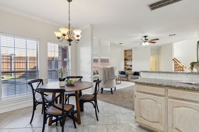 dining area with light tile patterned floors, light colored carpet, visible vents, ornamental molding, and ceiling fan with notable chandelier