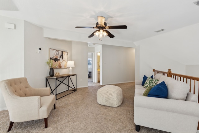 living area with light carpet, ceiling fan, visible vents, and baseboards