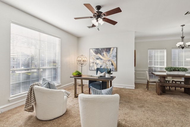 office featuring baseboards, ceiling fan with notable chandelier, visible vents, and light colored carpet