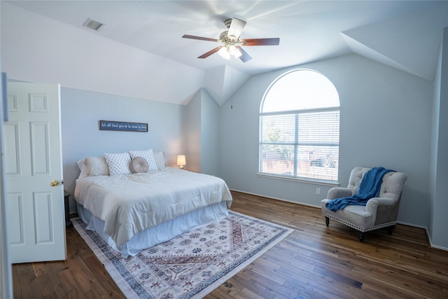 bedroom with a ceiling fan, lofted ceiling, visible vents, and dark wood finished floors