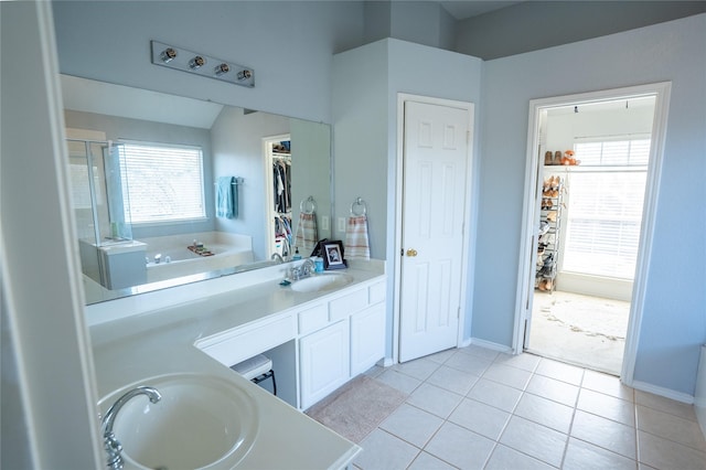 bathroom with plenty of natural light, a sink, and double vanity