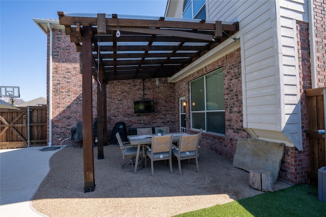 view of patio with outdoor dining area, fence, and a pergola