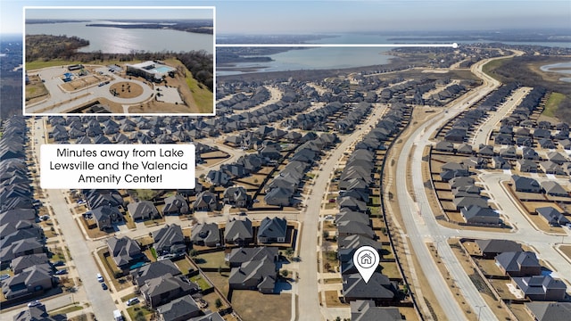 drone / aerial view featuring a water view and a residential view