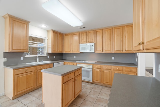 kitchen with a center island, visible vents, light tile patterned flooring, a sink, and white appliances