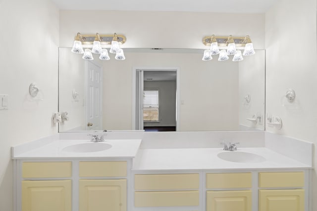 bathroom featuring a sink and double vanity