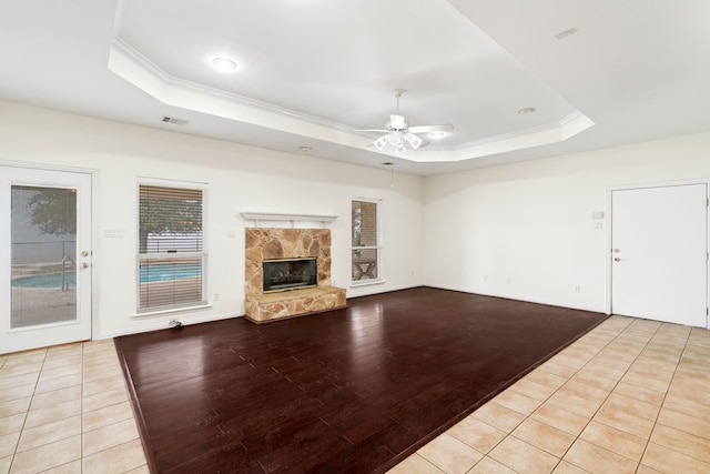 unfurnished living room with visible vents, a raised ceiling, and crown molding