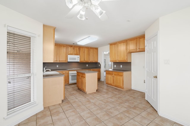 kitchen featuring light brown cabinets, white appliances, light tile patterned flooring, and a kitchen island