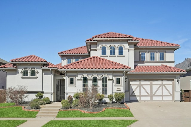 mediterranean / spanish-style home featuring stucco siding, concrete driveway, and a tile roof