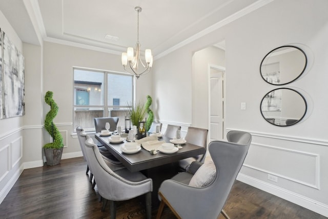 dining room featuring dark wood-style floors, wainscoting, a chandelier, and crown molding