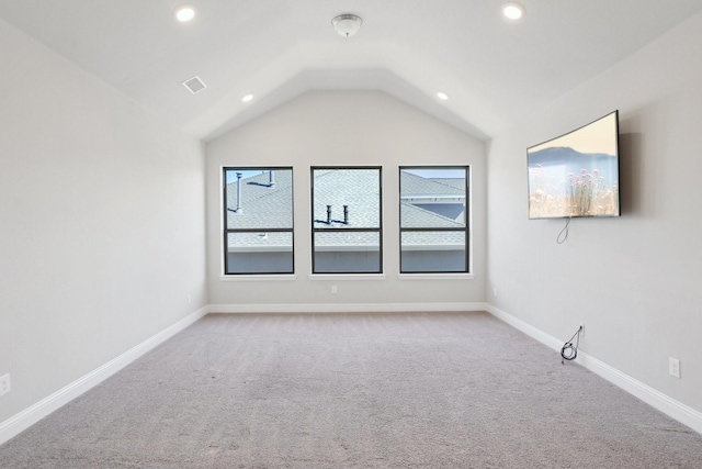 spare room with lofted ceiling, recessed lighting, visible vents, and baseboards