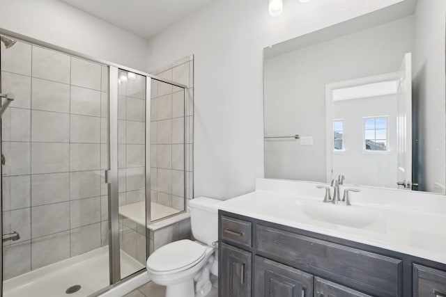 bathroom featuring a shower stall, vanity, and toilet