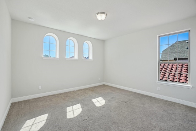 empty room with light carpet and baseboards