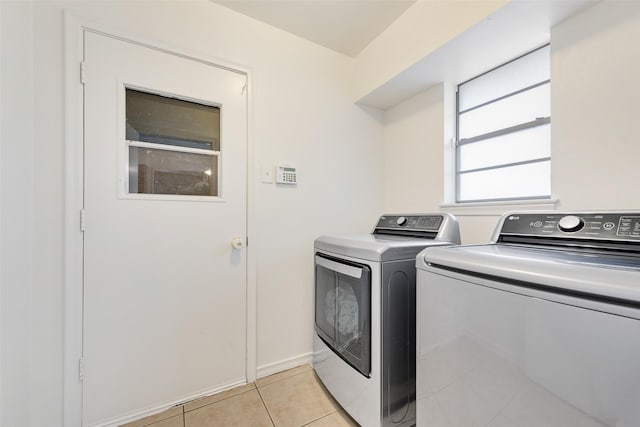 laundry room with laundry area, light tile patterned floors, and separate washer and dryer