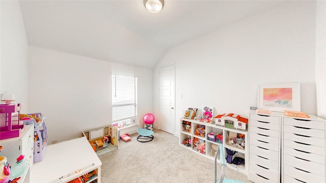 recreation room featuring vaulted ceiling and carpet